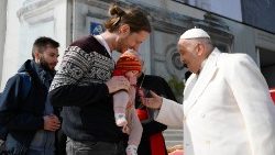 Pope blessing a young family