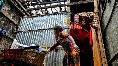 A Rohingya refugee collects her belongings in a house in Nayapara refugee camp in Bangladesh a day after Cyclone Mocha made landfall in May 15, 2023.