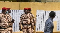 Soldiers stand guard near a polling station in the Chadian capitol N'Djamena during the presidential election