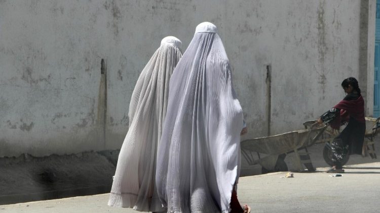 Afghan women banned from baring their faces and speaking in public