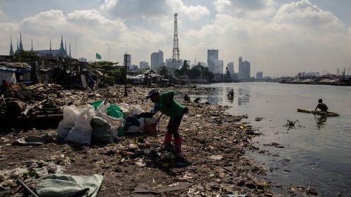 File photo of a member of the River Warriors raking through washed up trash from the polluted Pasig River in Manila, Philippines (Reuters, 2021)
