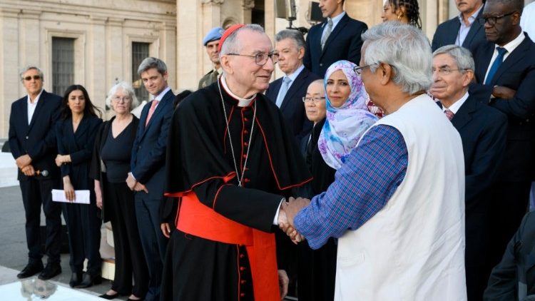 Muhammad Yunus, right, shakes hands with Vatican Secretary of State Cardinal Pietro Parolin at the signing of the Declaration on Human Fraternity