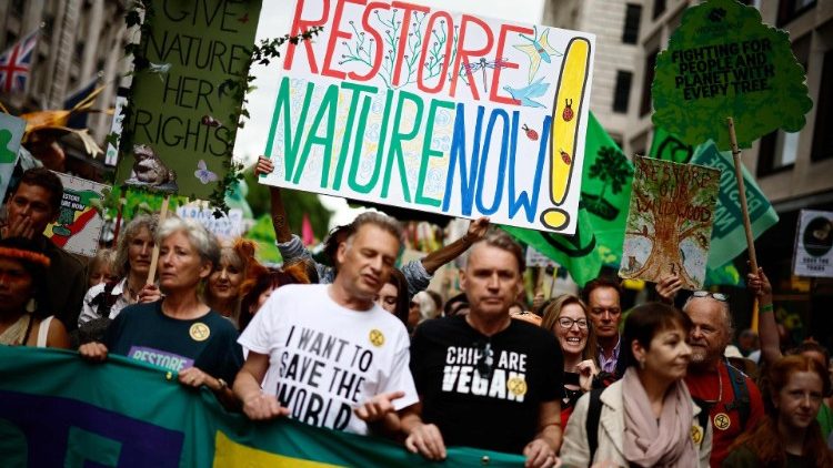 Environmentalist activists participate in a march  in London in June 2024