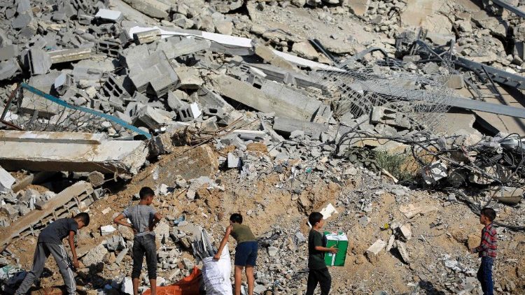 Crianças nos escombros de edifícios destruídos durante bombardeio israelense