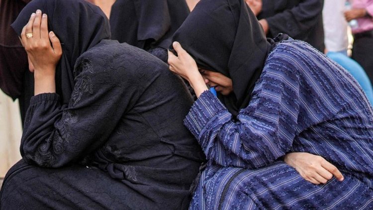 Women mourn the loss of their family members after Israeli bombardment in al-Maghazi, Gaza 