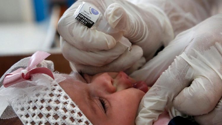 A polio vaccine is administered in a clinic in a refugee camp in the Gaza Strip