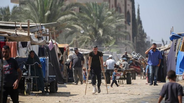 Displaced Palestinians leave the perimeter of the Al-Aqsa Martyrs Hospital in the Gaza Strip following renewed Israeli evacuation orders