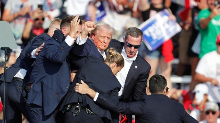 Donald Trump is led away by secret service agents after being shot at an election rally