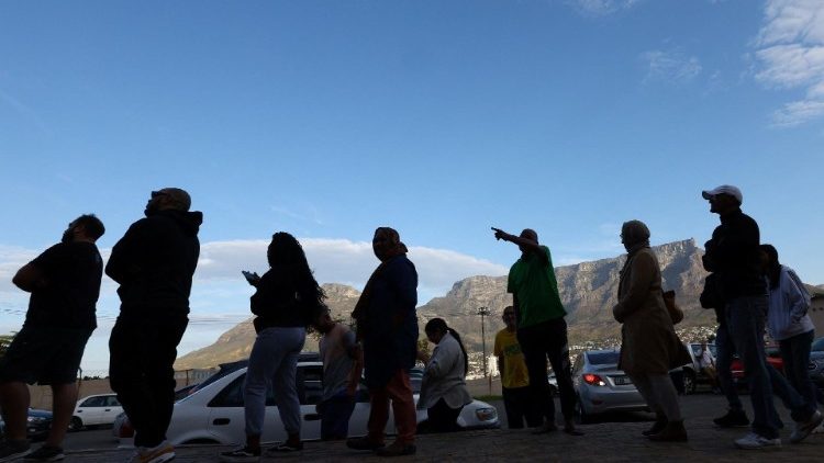 South Africans queue to cast their ballots in Cape Town with Table Mountain in the background