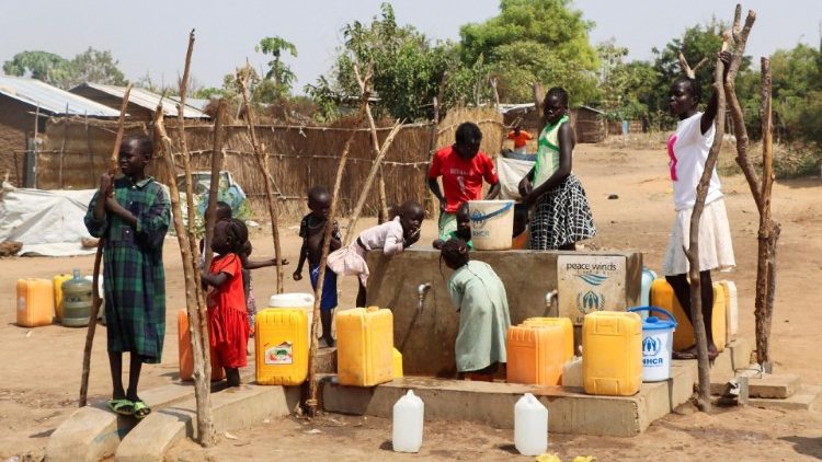 FILE PHOTO: Sudanese refugees collect water from a borehole at the Gorom Refugee camp