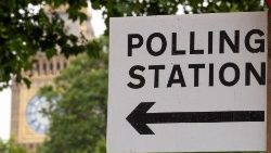 Polling station direction sign is seen in London ahead of general elections