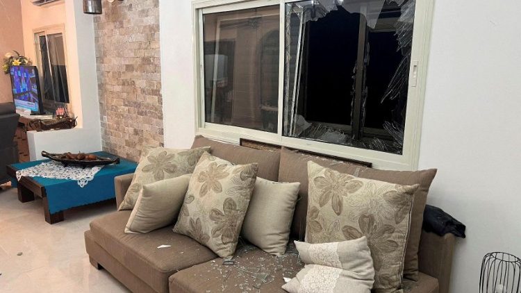 FILE PHOTO: Broken glass of a window is pictured in a house, caused by shrapnel from a rocket that landed after it was fired from Lebanon, amid cross-border hostilities between Hezbollah and Israeli forces, in Tzuriel