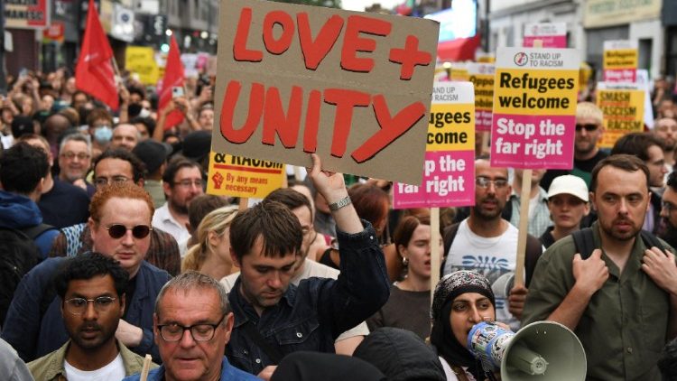 People gather in London to protest against anti-immigration riots