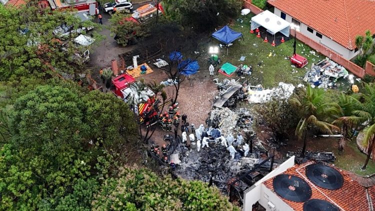 Officials work at the site of a plane crash in Vinhedo, Sao Paulo