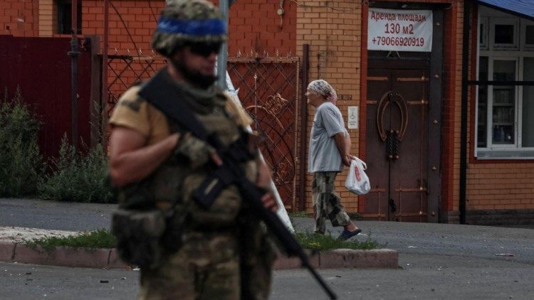 A Ukrainian serviceman patrols in the town of Sudzha