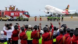 People wave as Pope Francis' Papal plane takes off, en route to Singapore, at the Presidente Nicolau Lobato International Airport in Dili