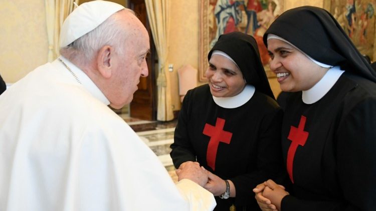 Pope Francis greets two of the nuns present at the audience