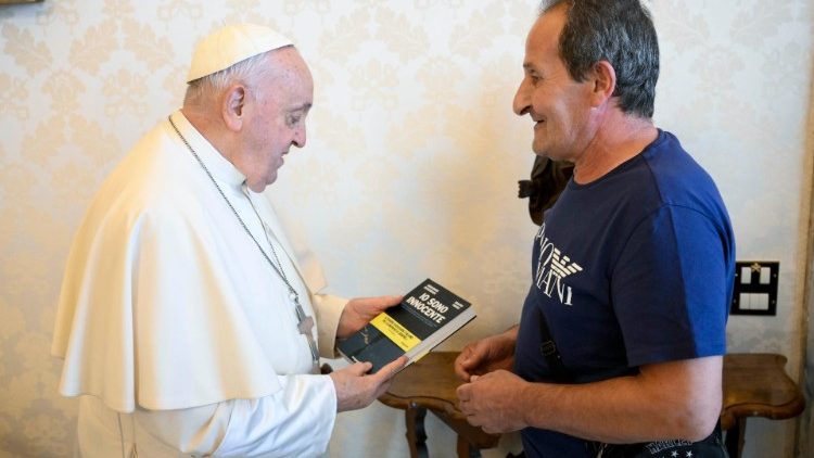 Mr. Zuncheddu hands the Pope a copy of his book