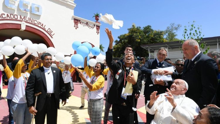 Pope Francis releases a dove outside the convention center in Dili