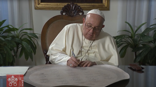 Pope Francis writing