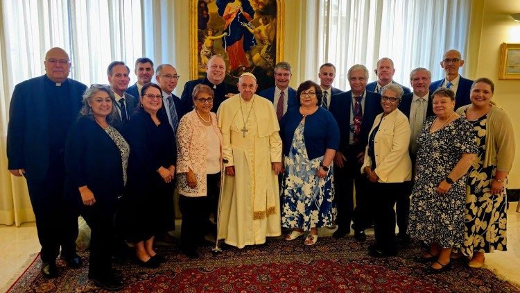 Pope Francis poses for a photo with the group