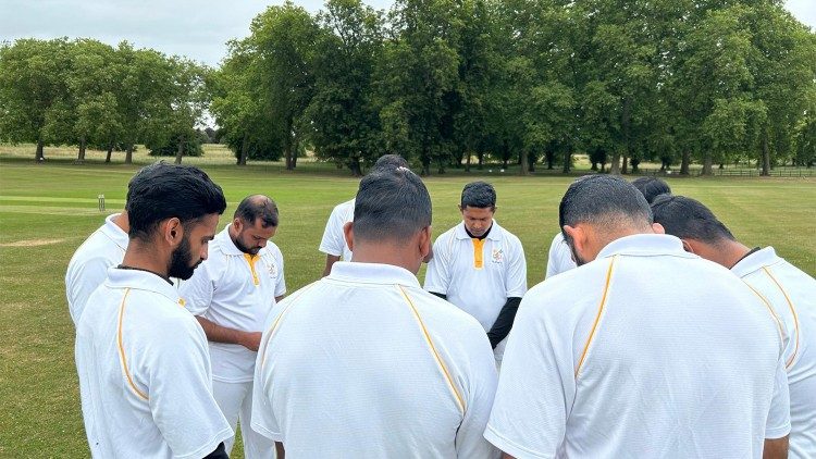 The Vatican team gathers in prayer before the match