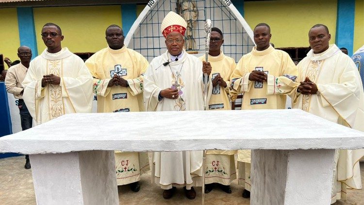 Mgr Oscar Nkolo, évêque de Mweka (RD Congo), entouré de nouveaux diacres et prêtres.