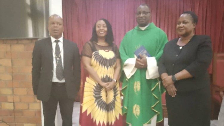 Fr Mwiila with some members of parliament (left) and the First Deputy Speaker (right)