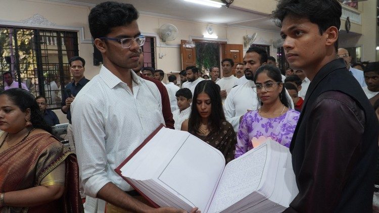 Two Bibles handwritten by parishioners in India