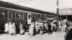 1905, la partenza di un pellegrinaggio con i primi barellieri che aiutano gli ammalati a salire sul treno (UNITALSI)