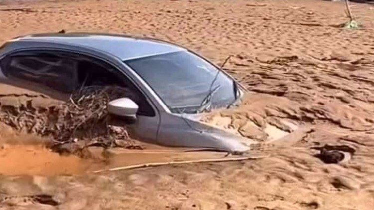 Cars remain buried in thick dried mud after the devastating floods in Chiang Rai, northern Thailand. Photo by Diocese of Chiang Rai