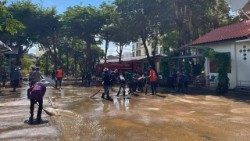 Volunteers work together to clean up mud and debris at the Diocese of Chiang Rai following Typhoon Yagi. (Photo by Diocese of Chiang Rai)