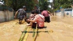 Residents in Myanmar use a makeshift bamboo raft to navigate through floodwaters after severe flooding caused by Typhoon Yagi. (Photo by Fr. Girish Santiago, SJ)