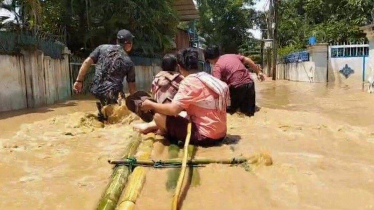 Residents in Myanmar use a makeshift bamboo raft to navigate through floodwaters after severe flooding caused by Typhoon Yagi. Photo by Fr. Girish Santiago, SJ