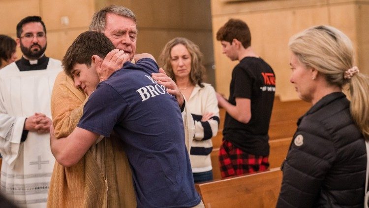 Pastor Msgr. Liam Kidney of Los Angeles' Corpus Christi church comforting parishioners after the Mass.  (Copyright: Archdiocese of Los Angeles/Isabel Cacho.)